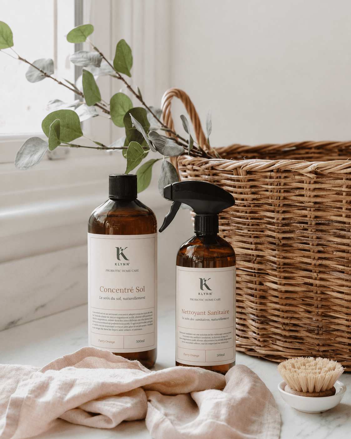 Le Duo Klynn dans une salle de bain, près d'un panier et d'eucalyptus, lumière douce